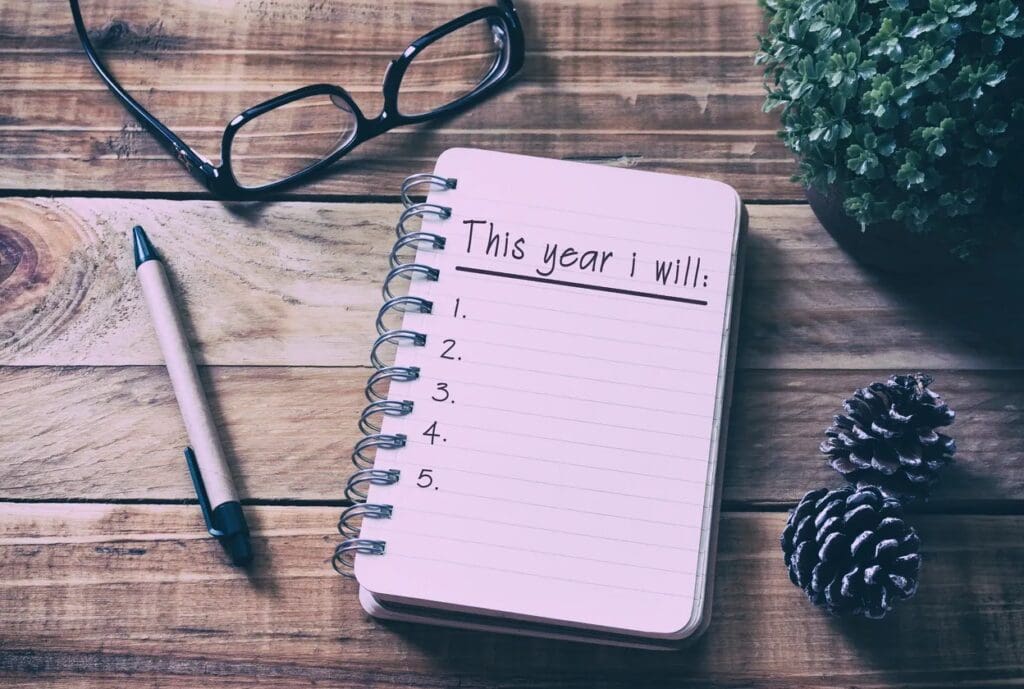 A notebook with the word this year will written on it.